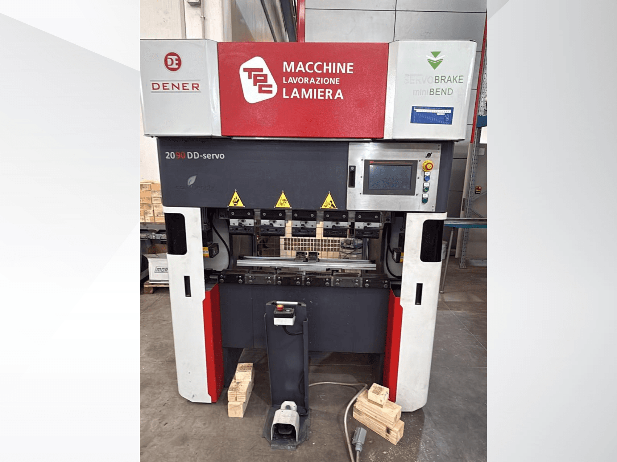 DENER DDS 2090 kantpress sett framifrån, med kontrollpanel, säkerhetsetiketter och stöd på träunderlag.