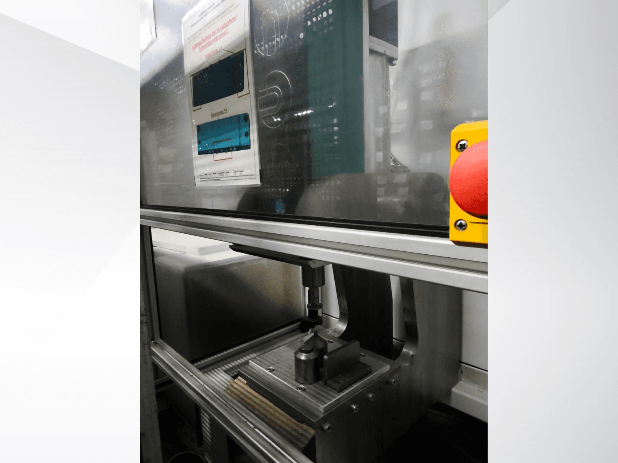 Frontvy av EMS Automation Buchsenpresse verktygsmaskin, med pressmekanism och säkerhetsknapp.