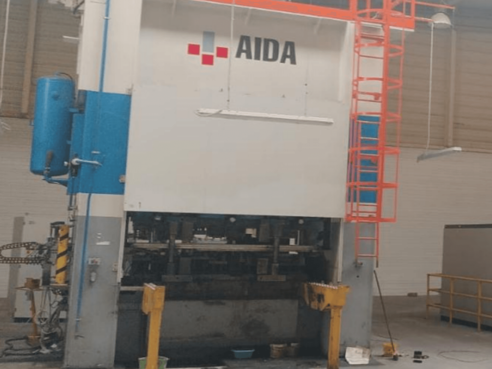 AIDA Mekanisk stanspress 315/2MR/LD/TE3, framifrån, med hydrauliska komponenter och säkerhetsstege.