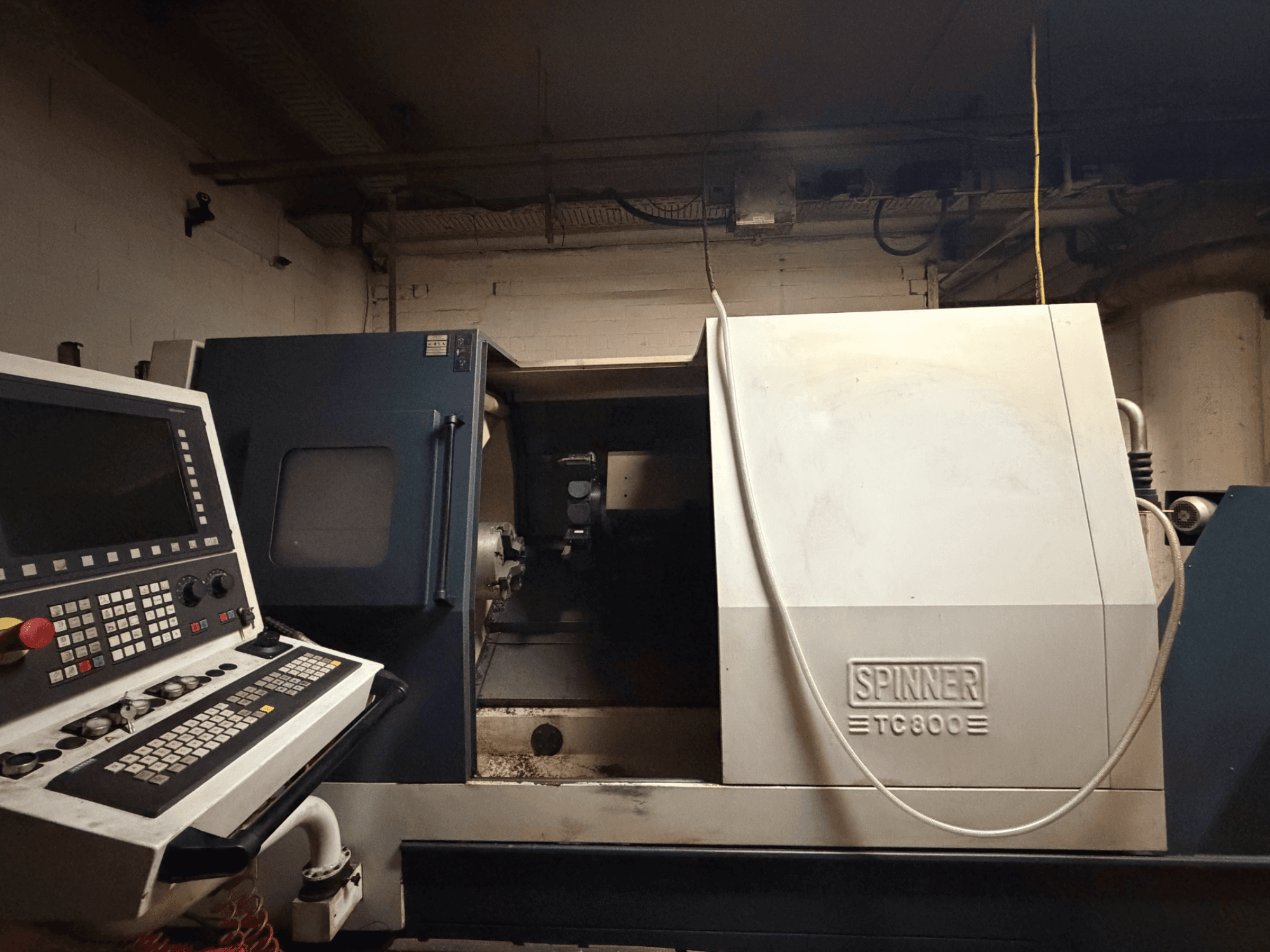 Horisontell svarv SPINNER TC800, framifrån med kontrollpanelen synlig och maskinens inre något exponerat.