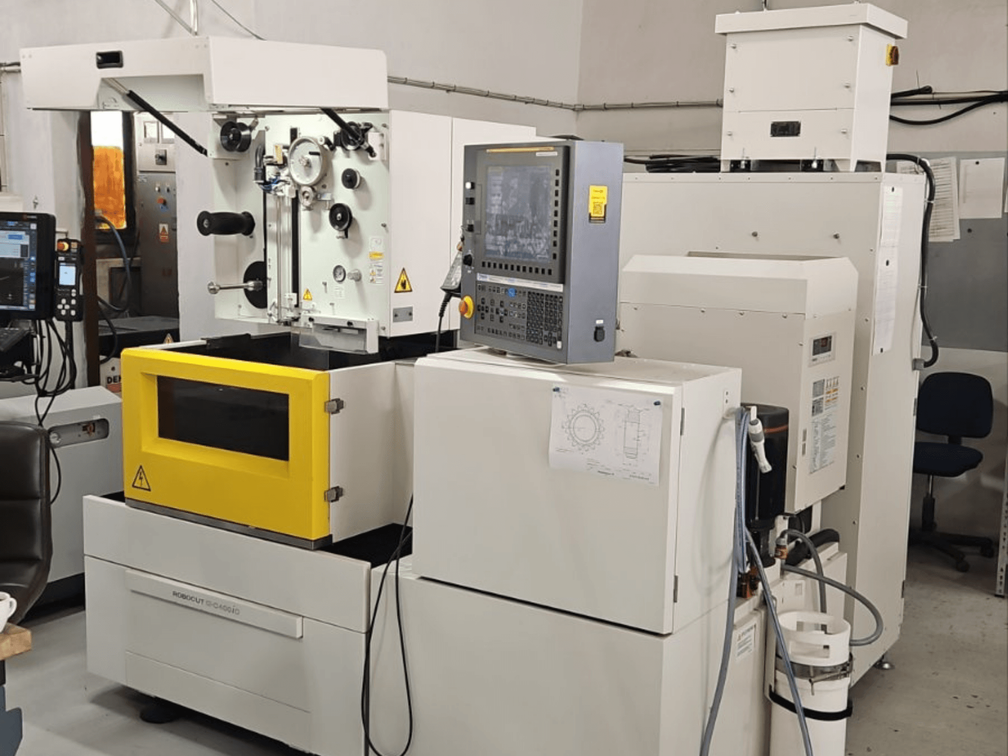 FANUC Robocut alpha C400iC trådgnistmaskin, framifrån med kontrollpanelen och den gula arbetskammaren i förgrunden.