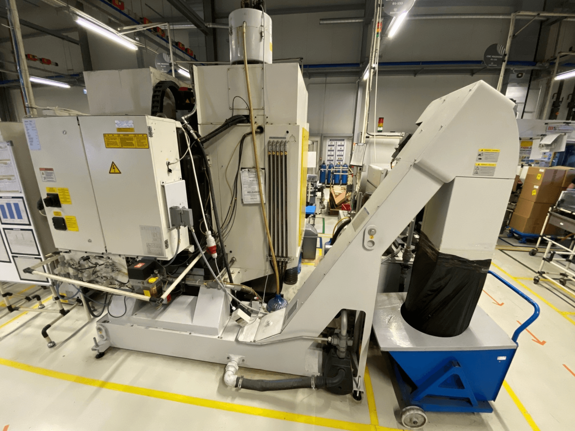 FANUC ROBODRILL α-D21LiB vertikalt bearbetningscenter, framifrån sett, med elektriska komponenter och utmatningsränna.