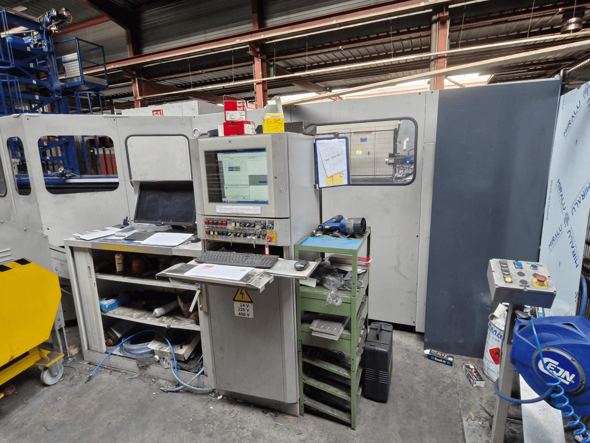 CNC-stansmaskin Salvagnini S4-40 i en verkstad, med en kontrollpanel med bildskärmar och verktyg, framifrån.