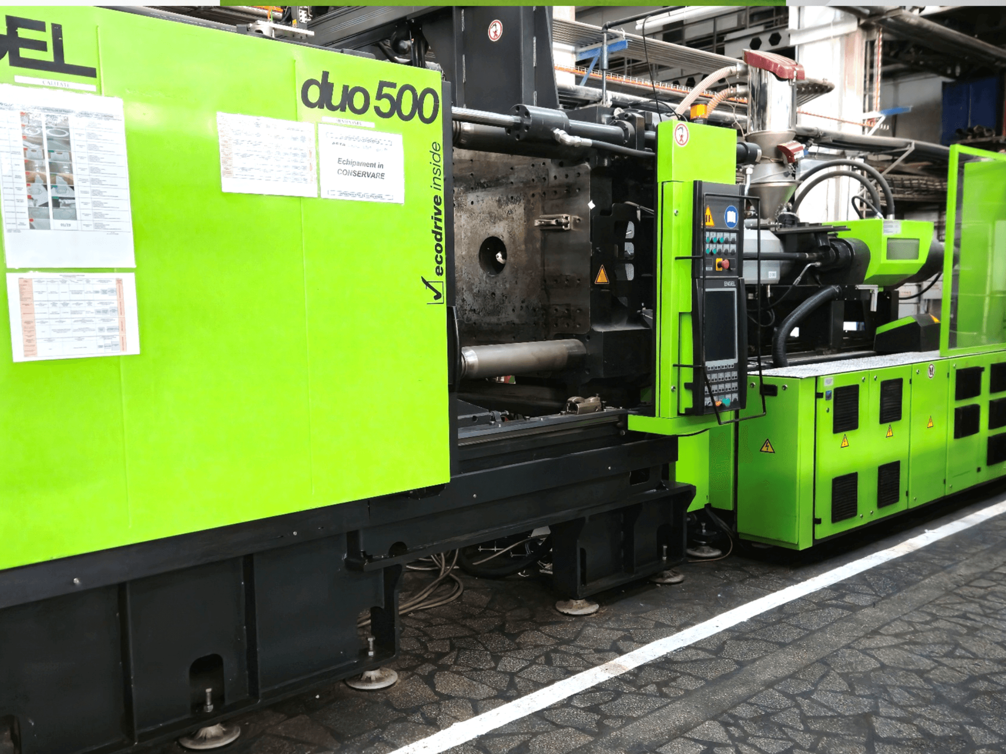 Grön industrimaskin Ergotron duo 500, vy framifrån; med kontrollpanel, tekniska detaljer och säkerhetsetiketter för utrustningen.