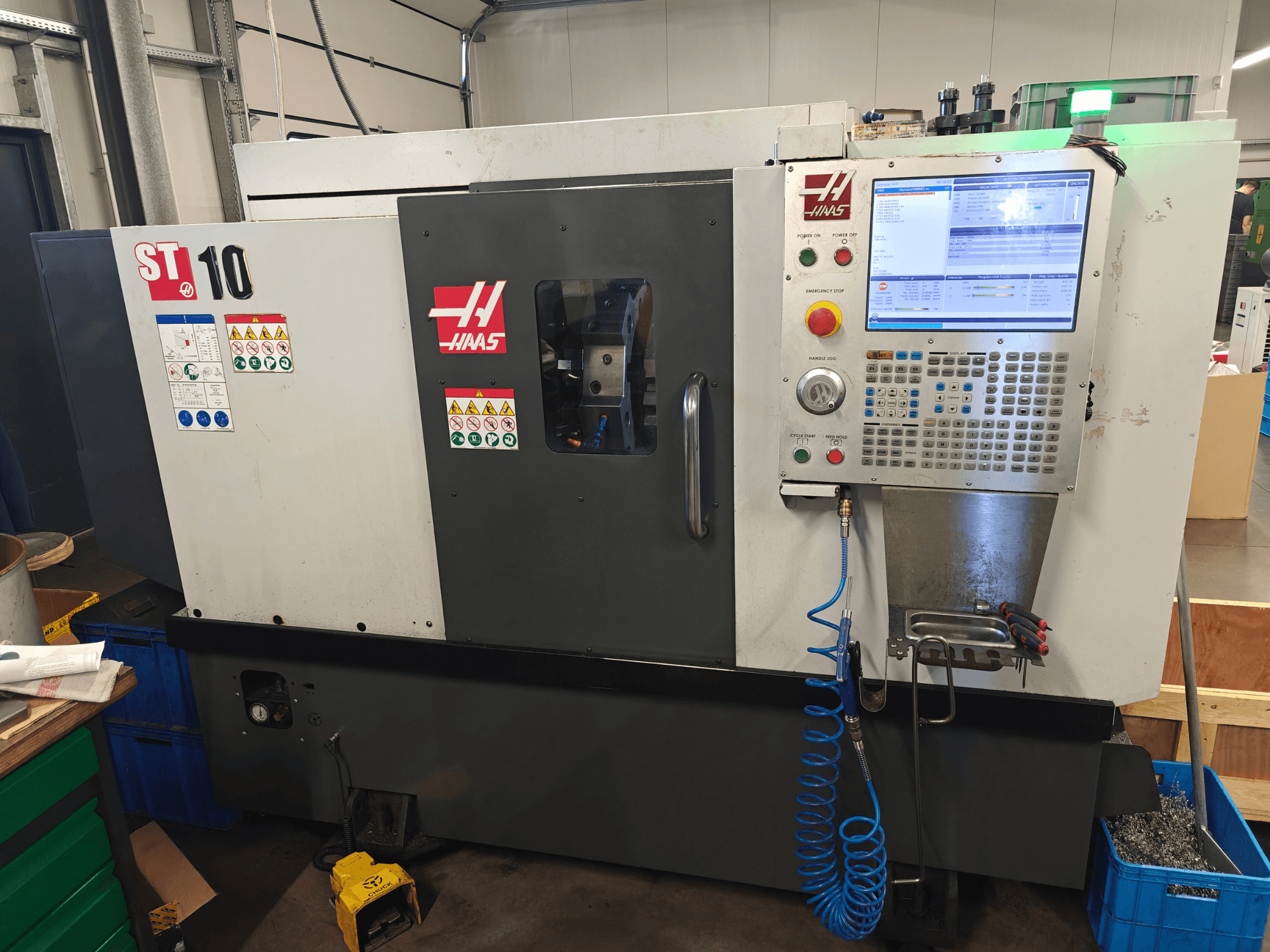Haas ST-10 horisontell svarv, framifrån, där man ser kontrollpanelen, säkerhetsetiketterna och maskinens konstruktion.