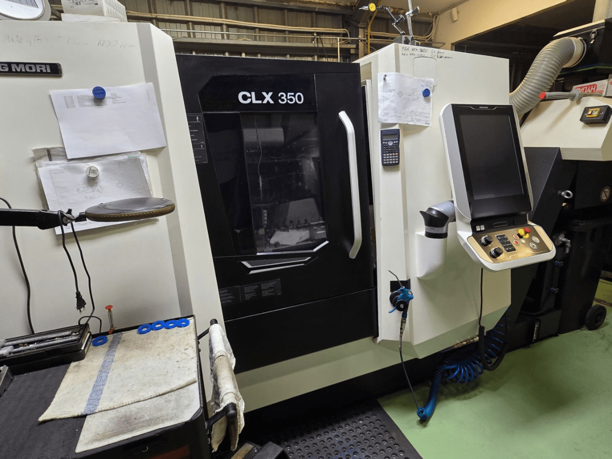 DMG MORI CLX 350 CNC-svarv i en verkstad; vy framifrån med kontrollpanel, verktyg och arbetsyta synliga.