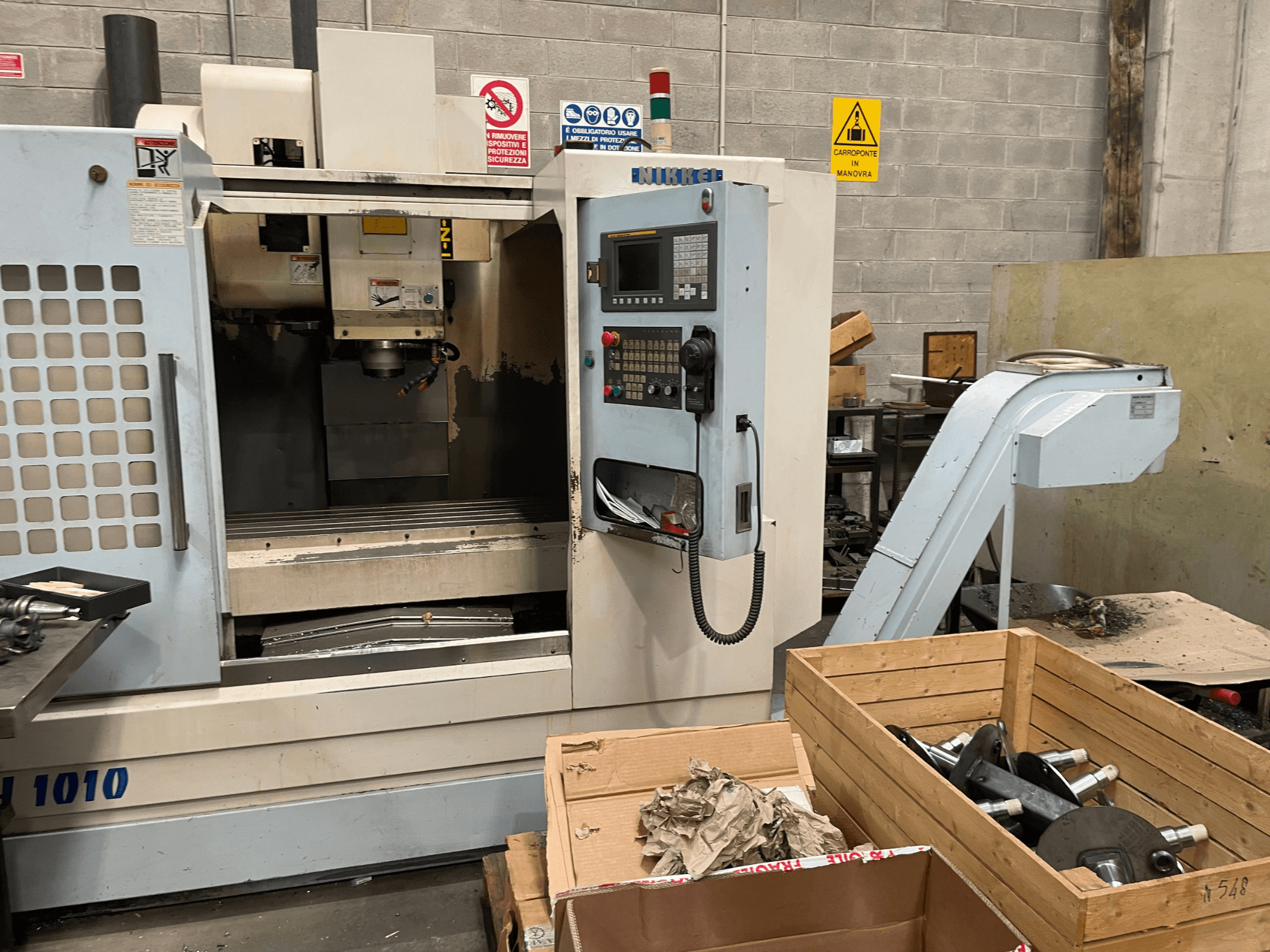 Vertikal fleroperationsmaskin av märket Other, modell VH-1010, sedd framifrån med synliga reglage och lådor i närheten.