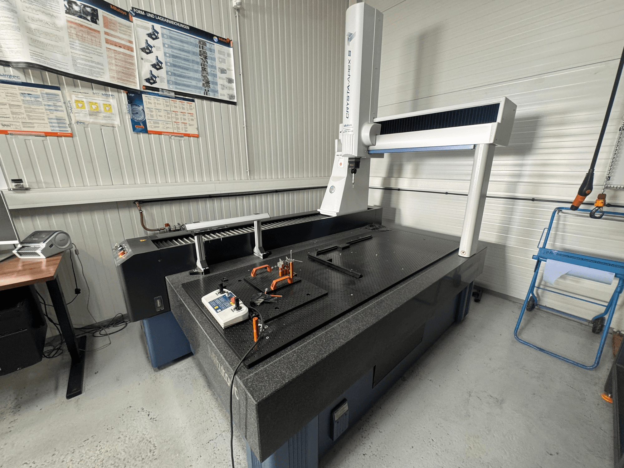 CMM koordinatmätmaskin från märket Leitz, framifrån på en texturerad svart yta med mätverktyg.