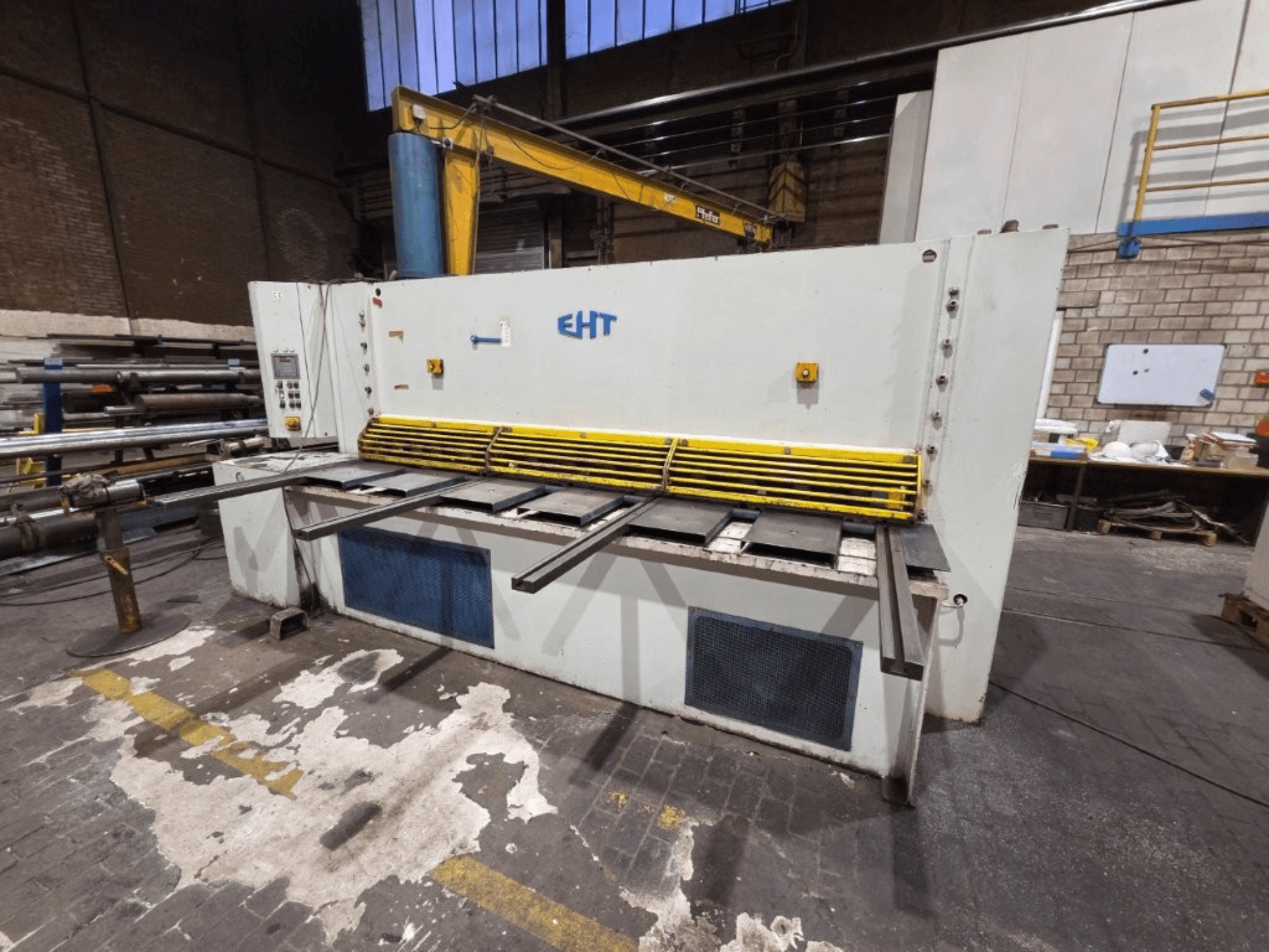 EHT hydraulisk skärmaskin sedd framifrån, med gult säkerhetsskydd och manöverpanel med reglage.