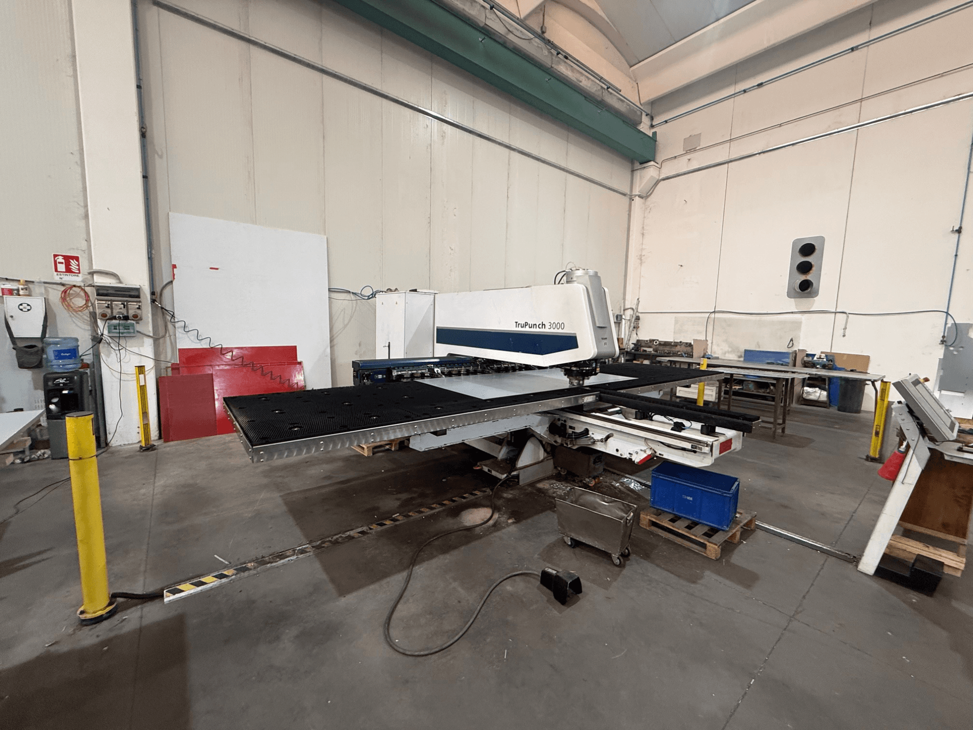 CNC-stansmaskin TRUMPF TruPunch 3000, sidovy, som visar stanshuvudet, det stora bordet och den omgivande verkstadsmiljön.