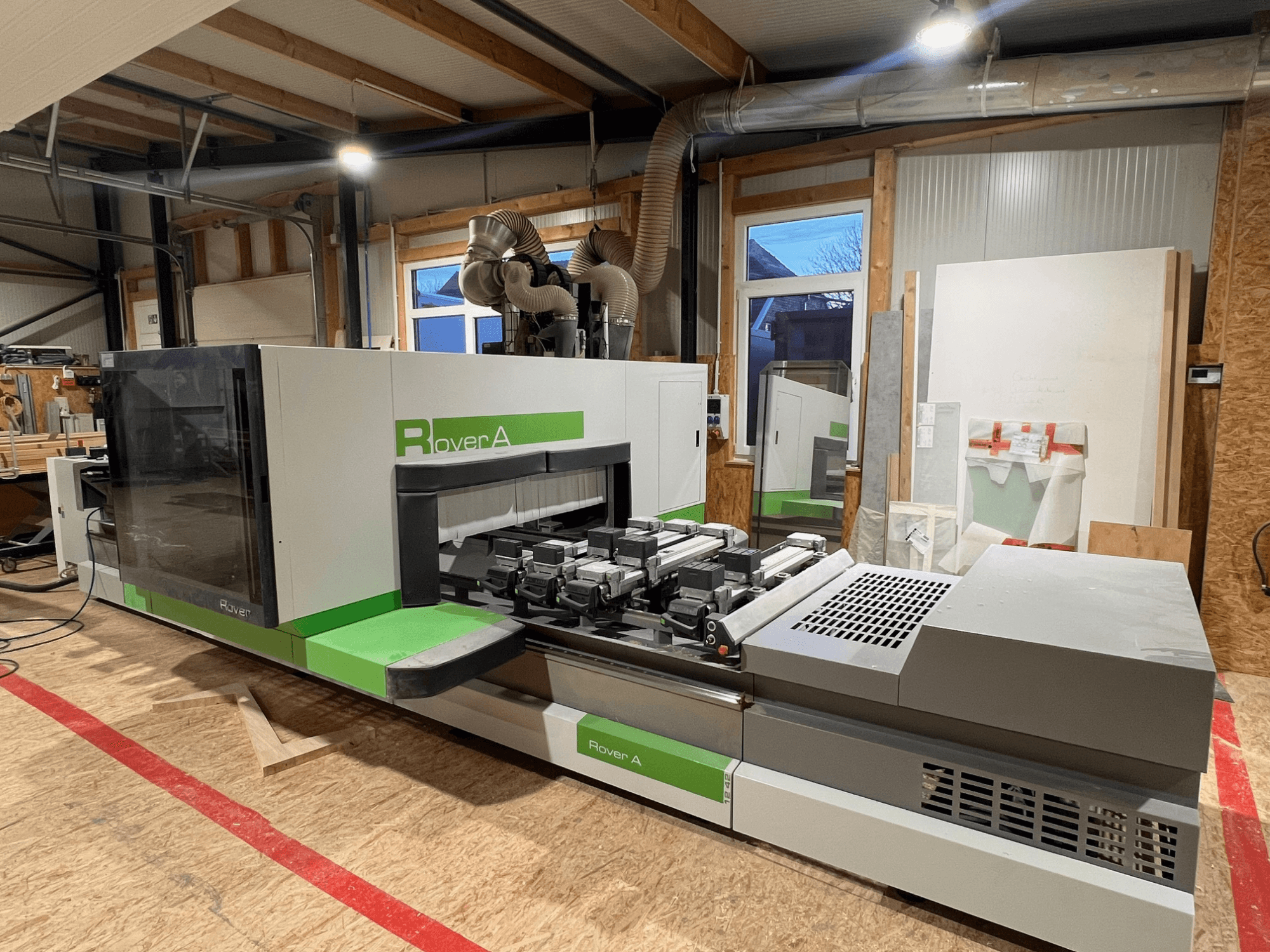 BIESSE Rover A 1242 CNC-bearbetningscenter för trä, framifrån visar kontrollpanelen och skärområdet i en verkstadsmiljö.