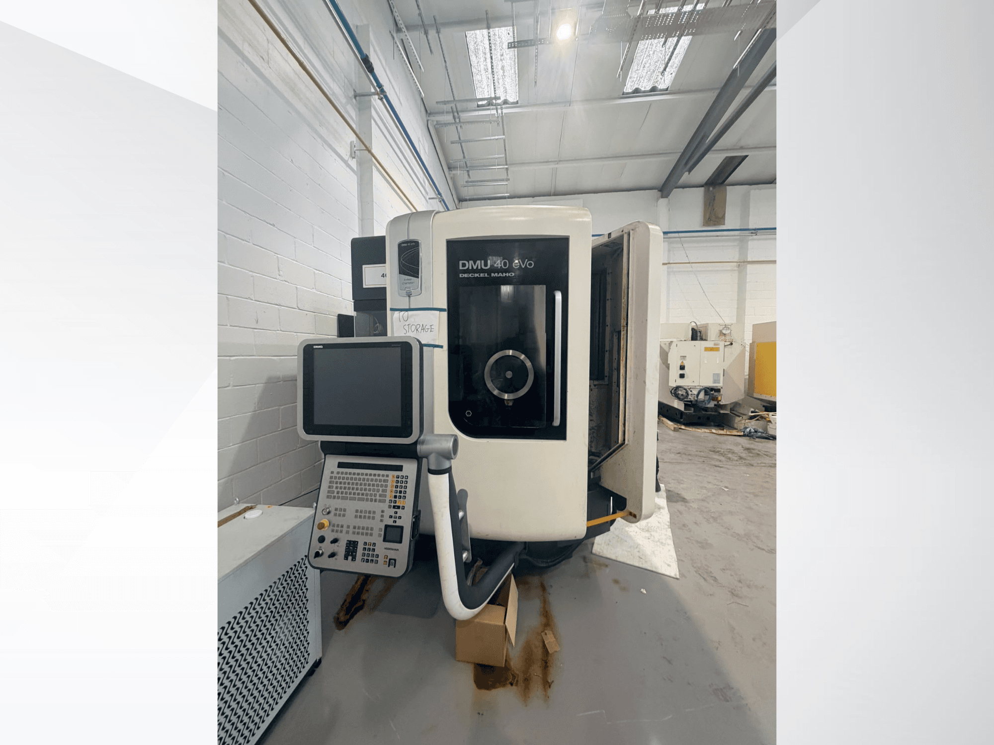 DMG DMU 40 evo vertikalt bearbetningscenter, framifrån sett, med kontrollpanelen och spindeldelen i förgrunden och arbetsområdet i bakgrunden.